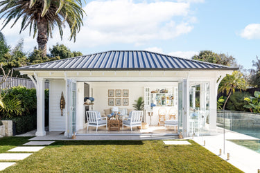 A poolshouse styled with Aflresco's new coastal collection for spring 2025.