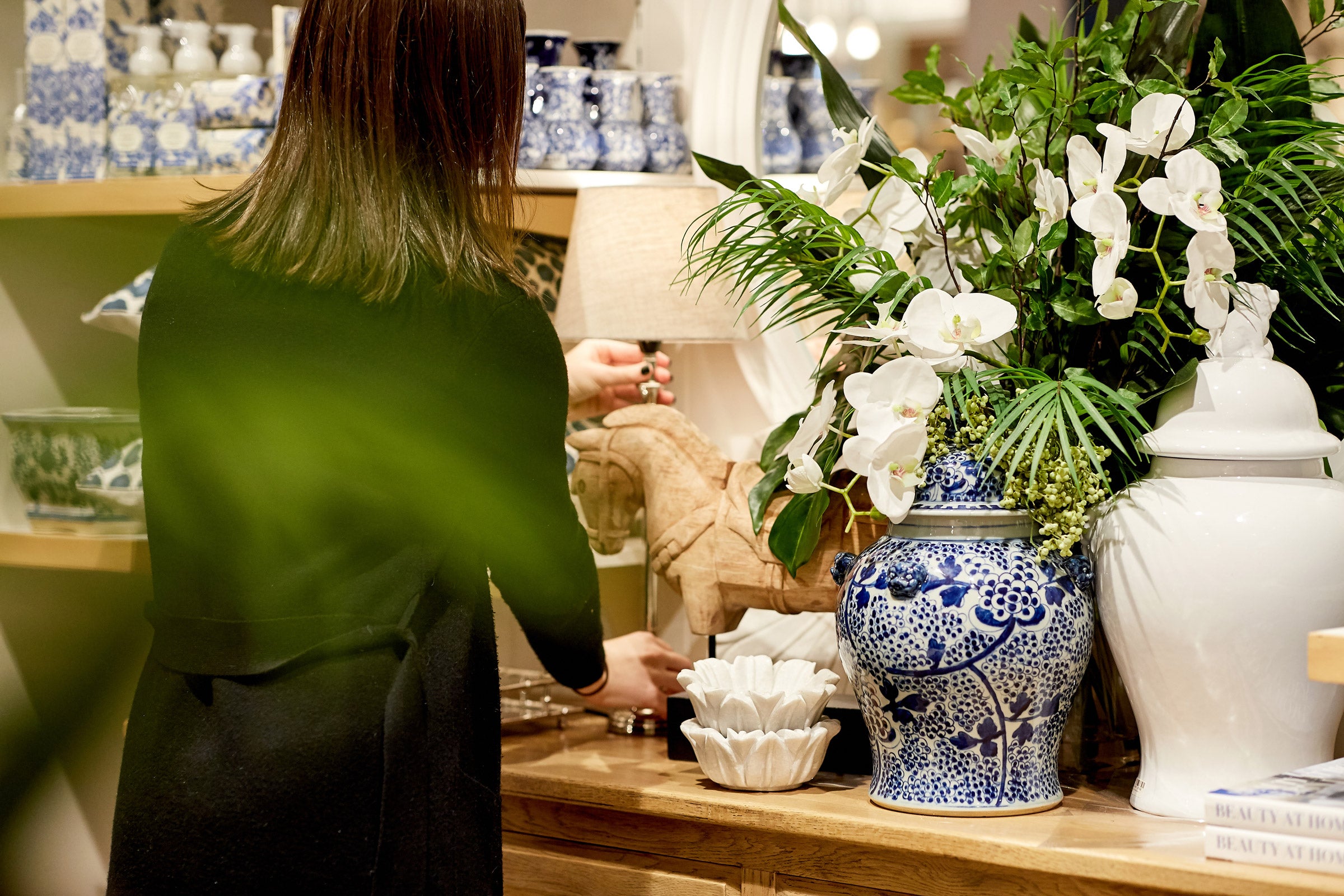 A sales team member adjusting a lamp in one of our beautiful store displays.