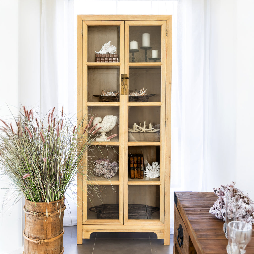 Bohai Two Door Bookcase with candles, ornaments and books on shelves