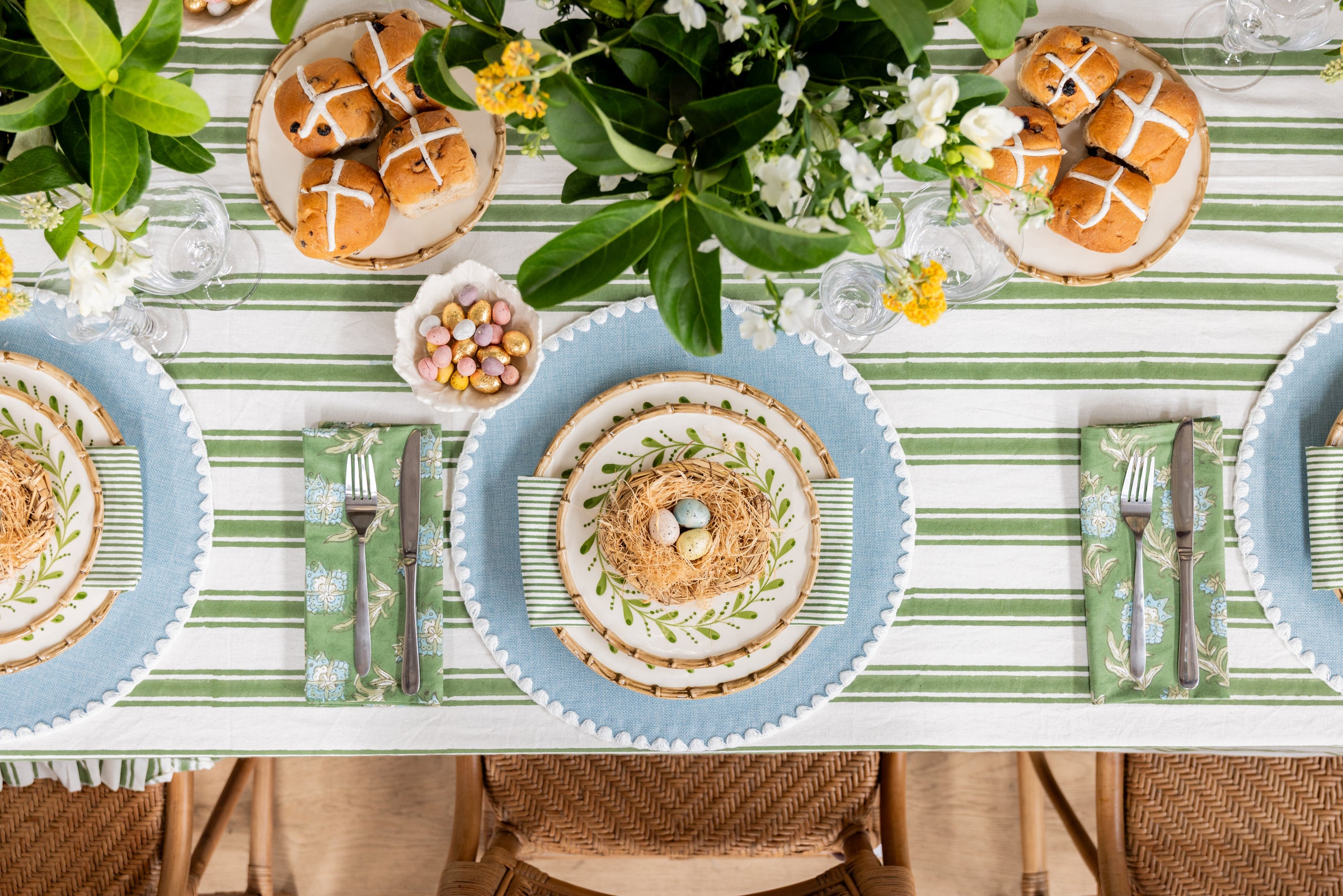 Easter Dining Table with Florals and Hot Cross Buns and Chocolate Eggs in Bowls