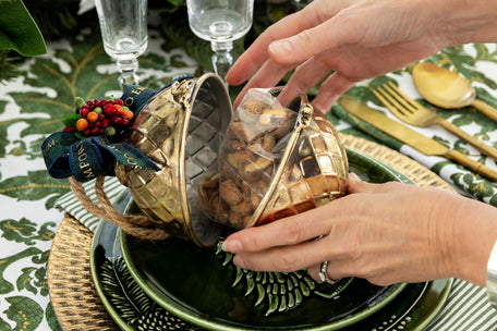 Open Gold Gift Bauble On A Dinner Plate.