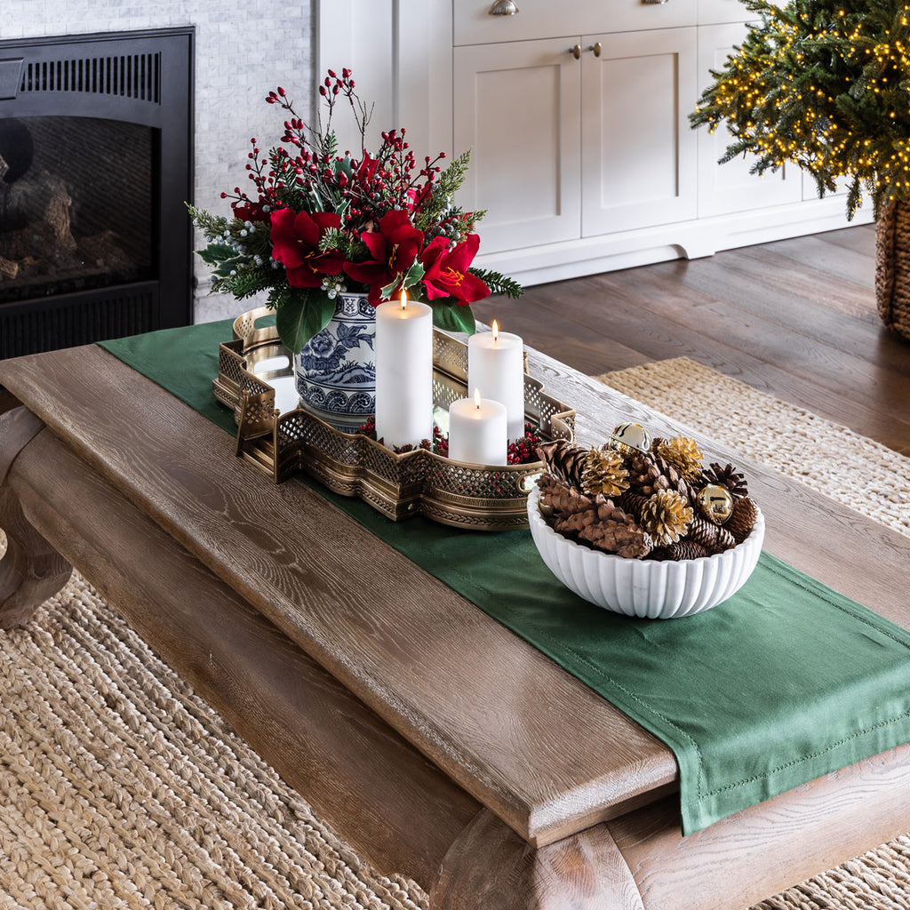 Green Christmas table runner on coffee table.