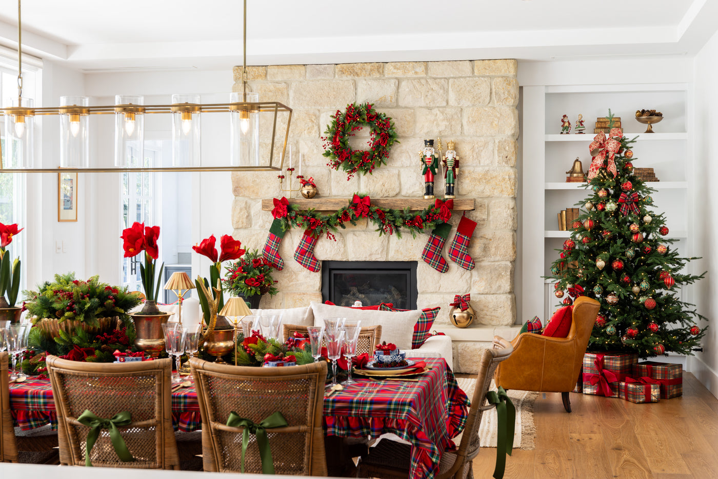 Living room with Christmas decorations including a tree, wreath, and table setting.