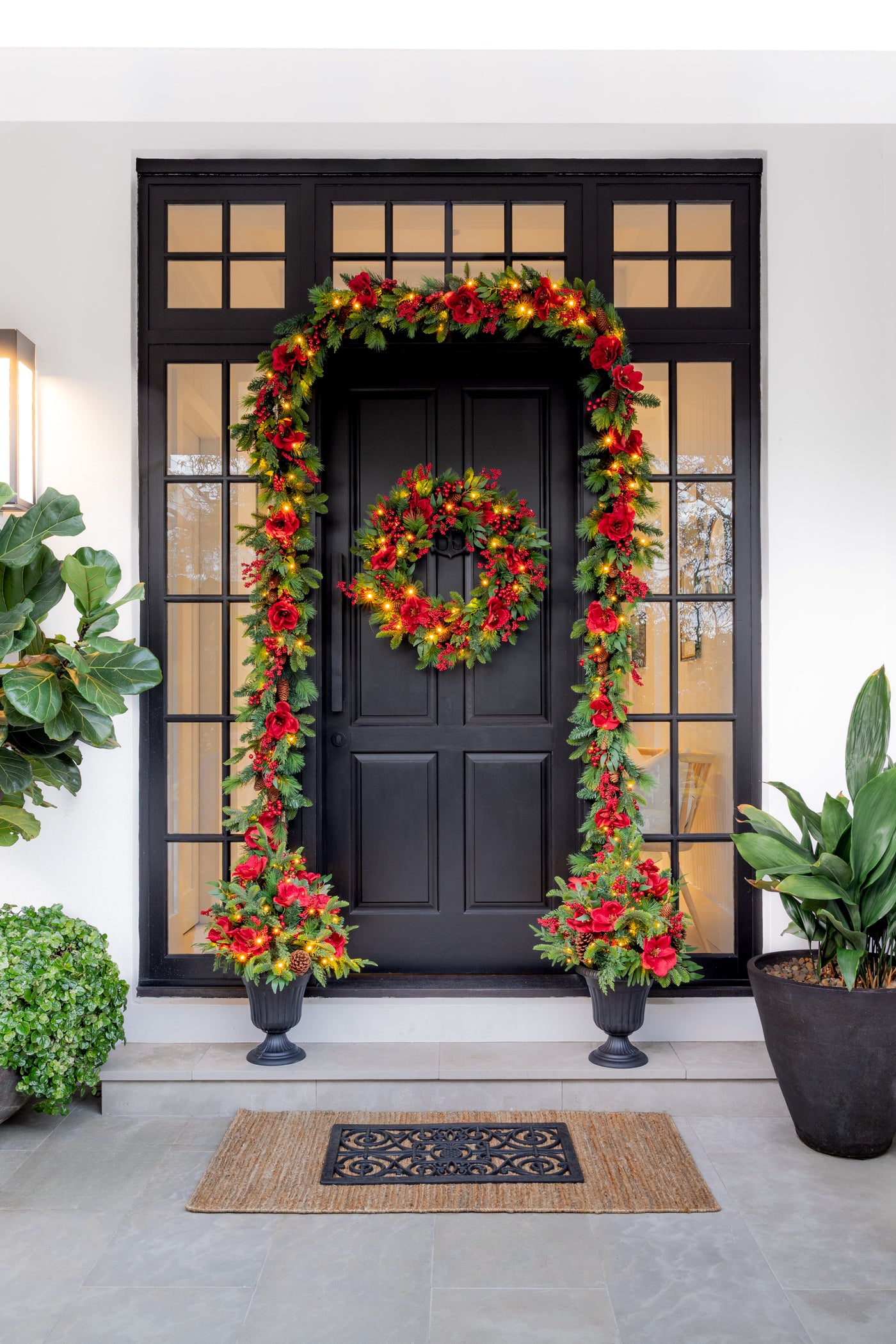 Black Door Styled with Red Magnolia Christmas Wreath and Garland and Arrangements on the Stairs
