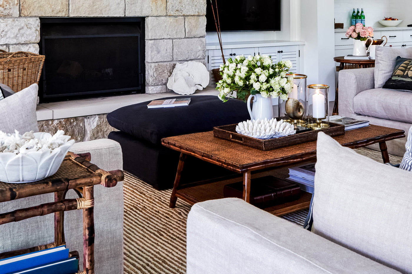 A beautiful living room featuring a bamboo coffee table and sisal rug.