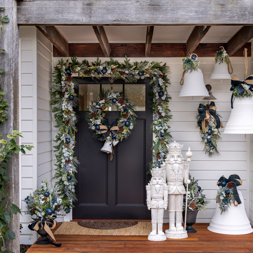 Blueberry garland around a blue door with a Christmas wreath.