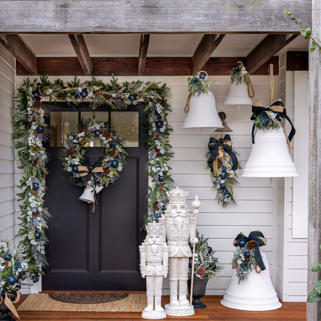 White Christmas Bells hanging from rafters near a front door.