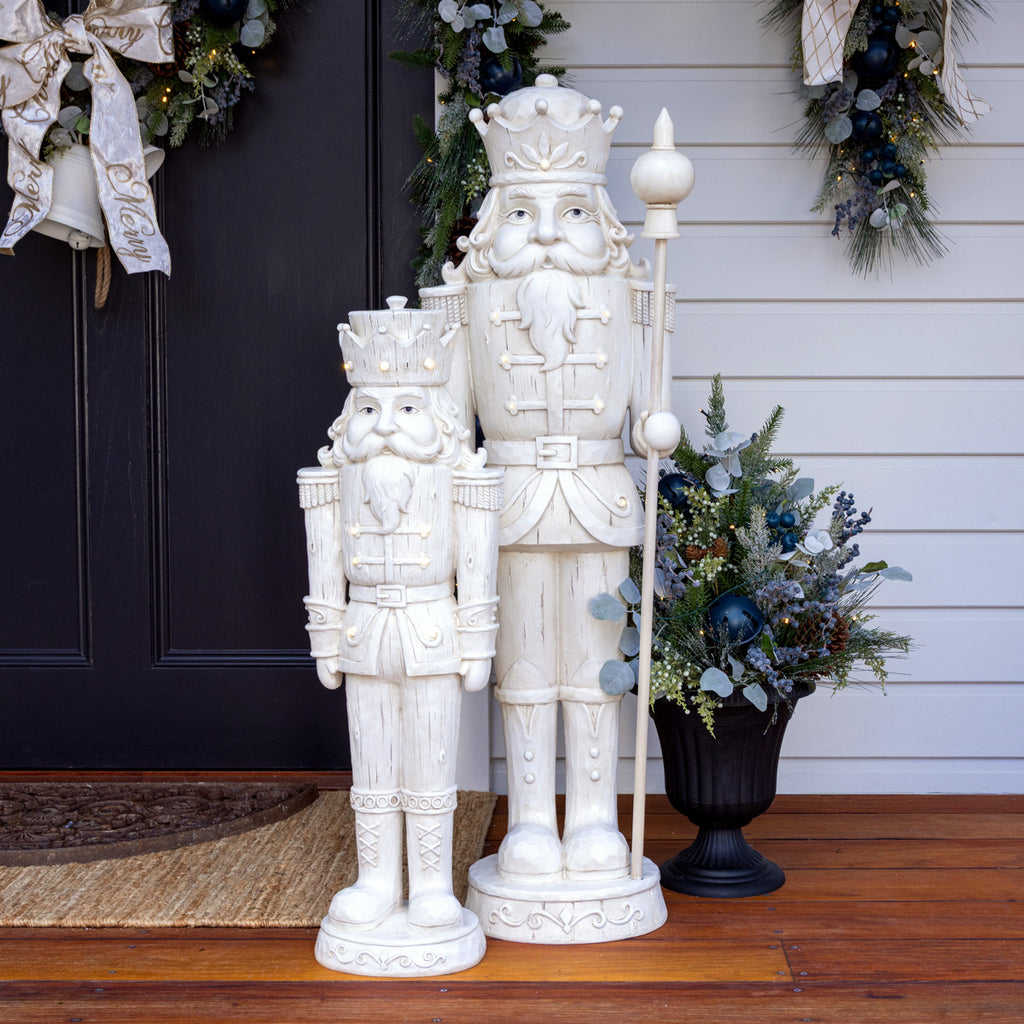 White christmas nutcrackers in front of blue door.