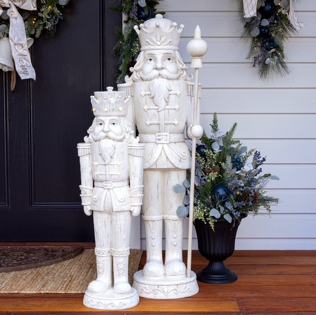 Blueberry vase arrangement styled next to some Christmas nutcrackers.