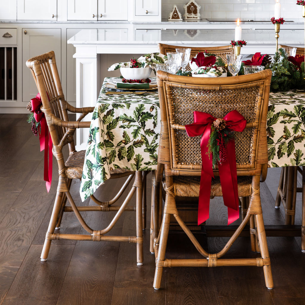 Red ribbon tied into bows on chair backs.