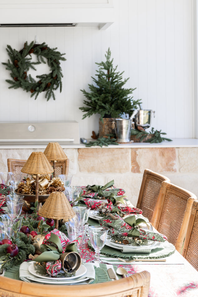 Christmas Dining Table with Festive green napkins and rattan cordless lamps