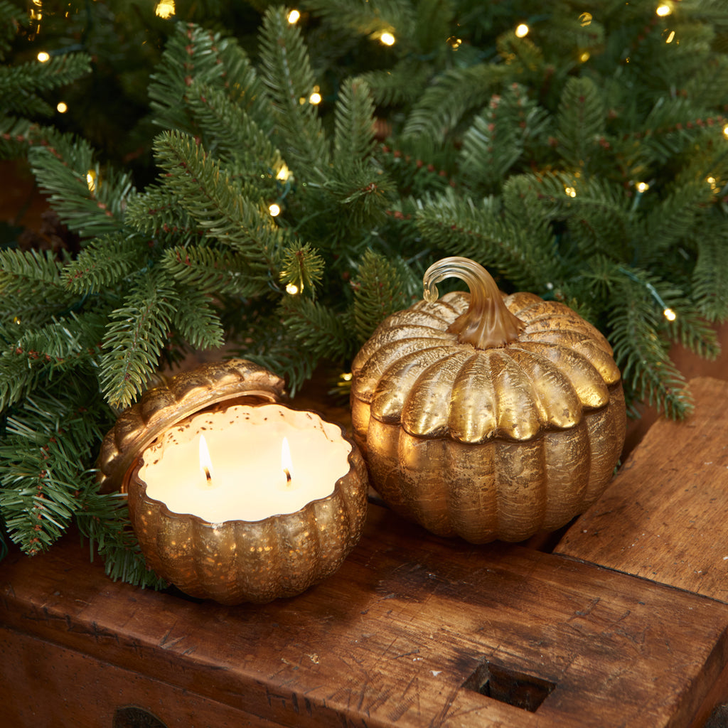 Pumpkin spice candles with Christmas garland in the background.