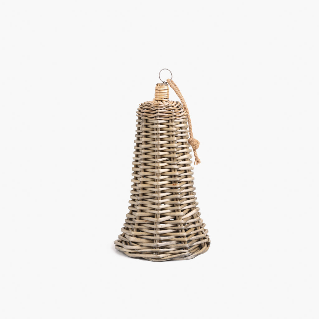 A small natural woven wicker bell-shaped hanging ornament with a small metal ring at the top and a knotted cord, shown on a plain light gray background.
