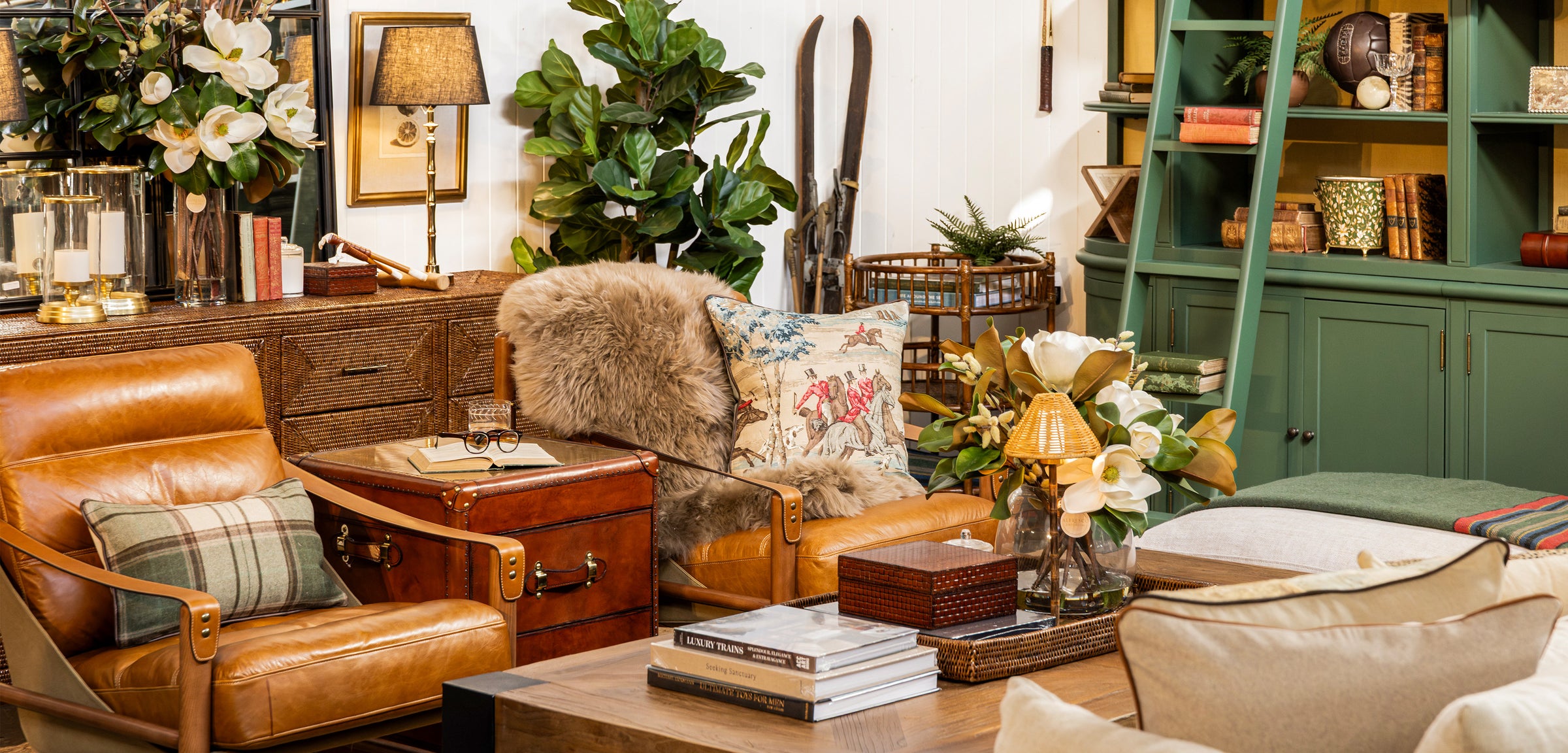 Living room with brown leather armchair, leather coffee table, and decorative items.