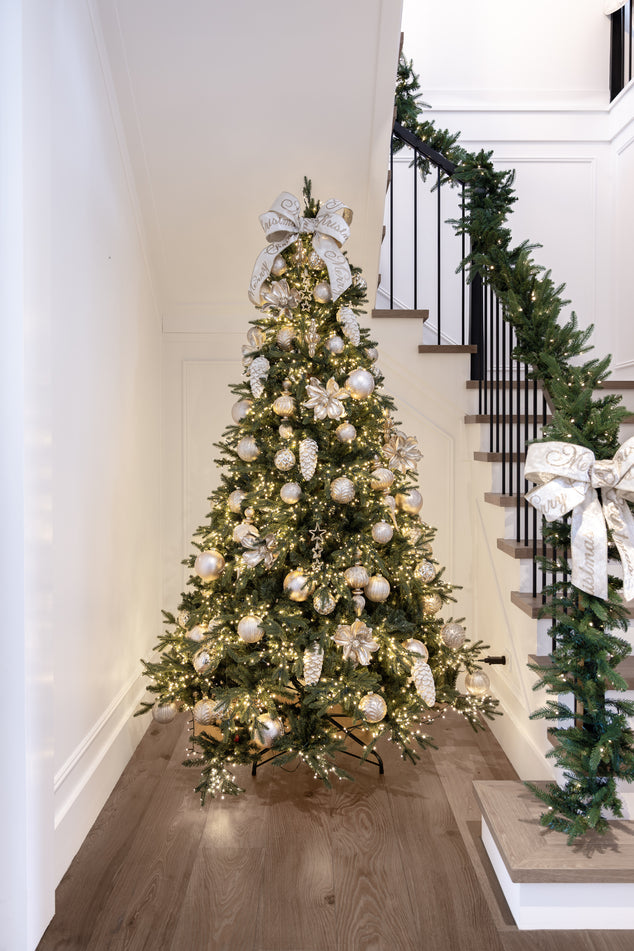 Christmas Tree in Stairway Styled with Champagne Gold Baubles and White Ribbon Bow on Top