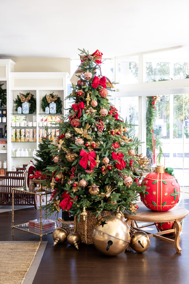 Vail Christmas Tree Styled with Red and Gold Baubles and Ornaments with Gold Bells in Front 