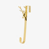 Gold hook with deer head design on a white background