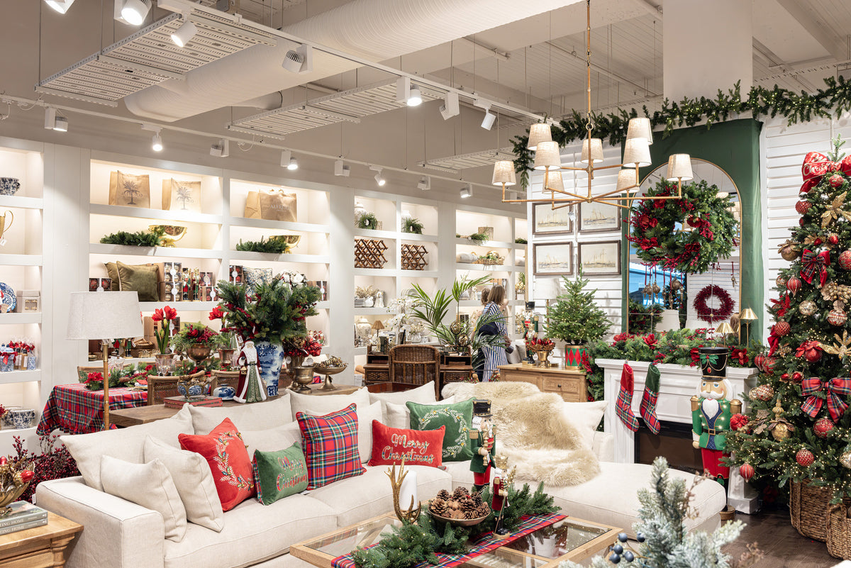 Decorated store interior with Christmas-themed products and furniture.