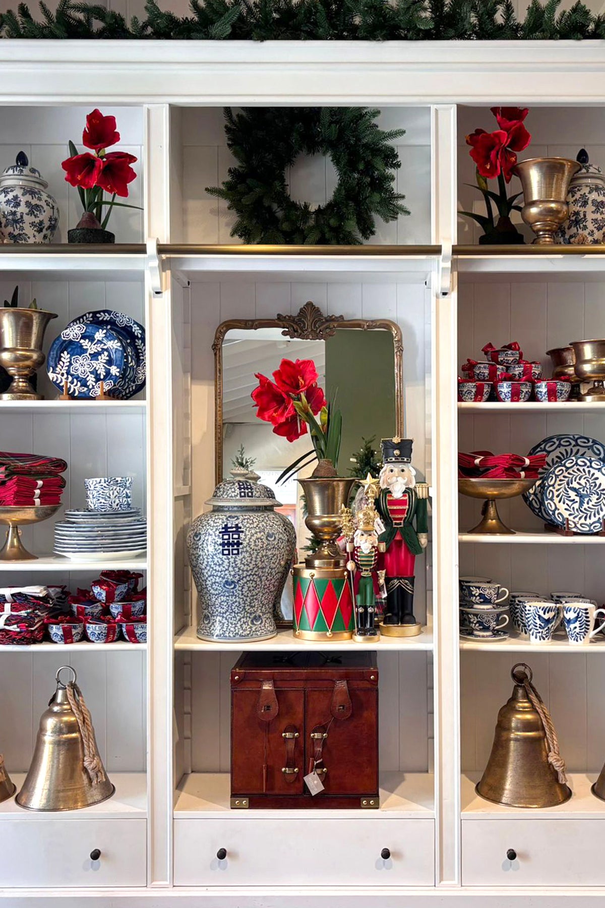 Decorative shelves with various items including vases, a wreath, and small figurines.