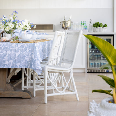 Antigua Rattan Chair (White) Styled at Outdoor Dining Table