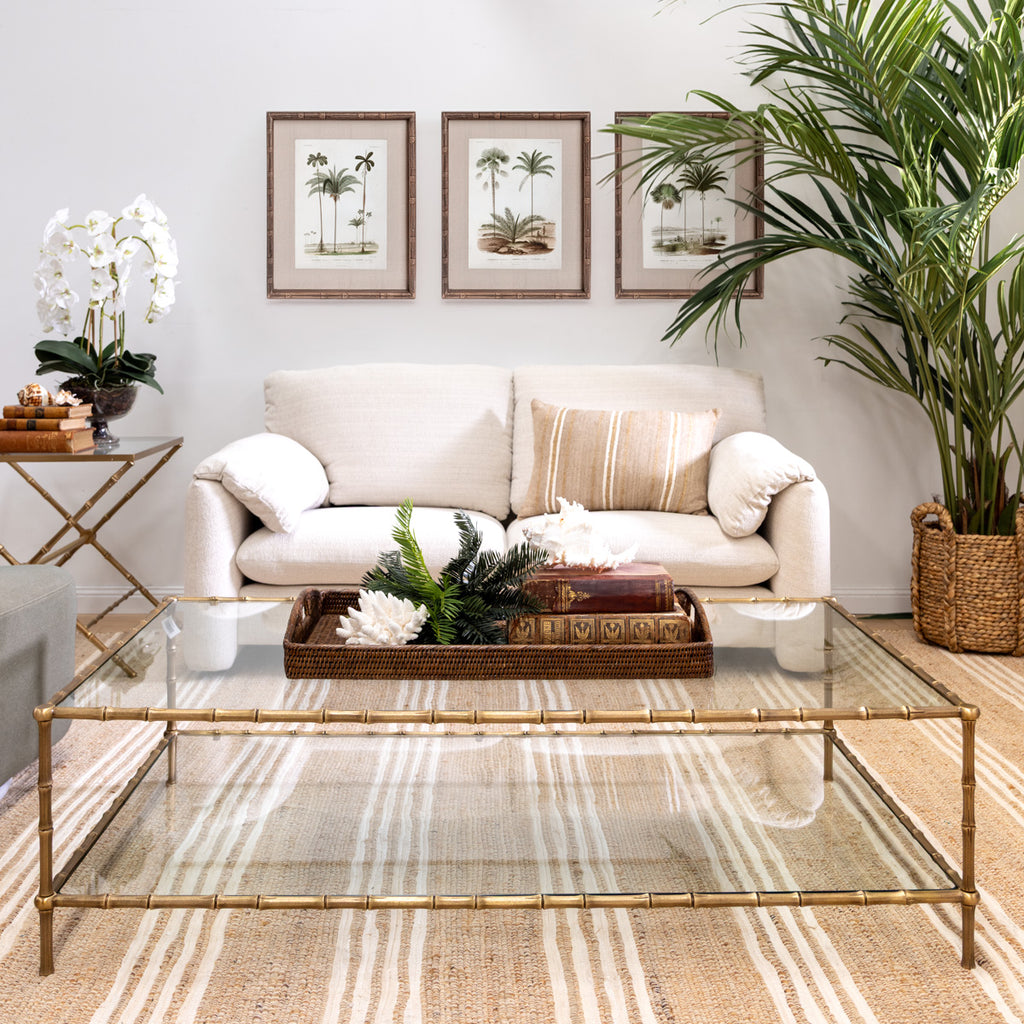 St Kitts Glass & Brass Bamboo Coffee Table Styled in Living Room with Sofa and Prints on the Wall
