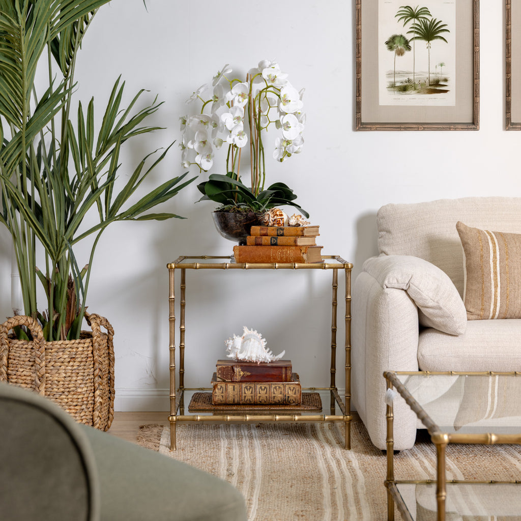 St Kitts Glass & Brass Bamboo Side Table Styled in Living Room with Plant and Sofa