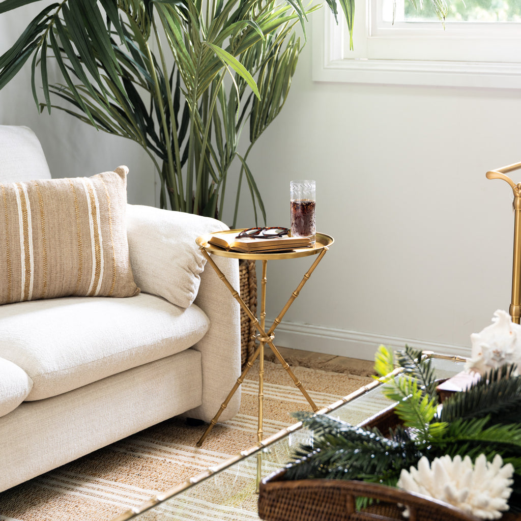 St Kitts Glass & Brass Bamboo Tripod Side Table Styled in Living Room with Book and Drink Near Window