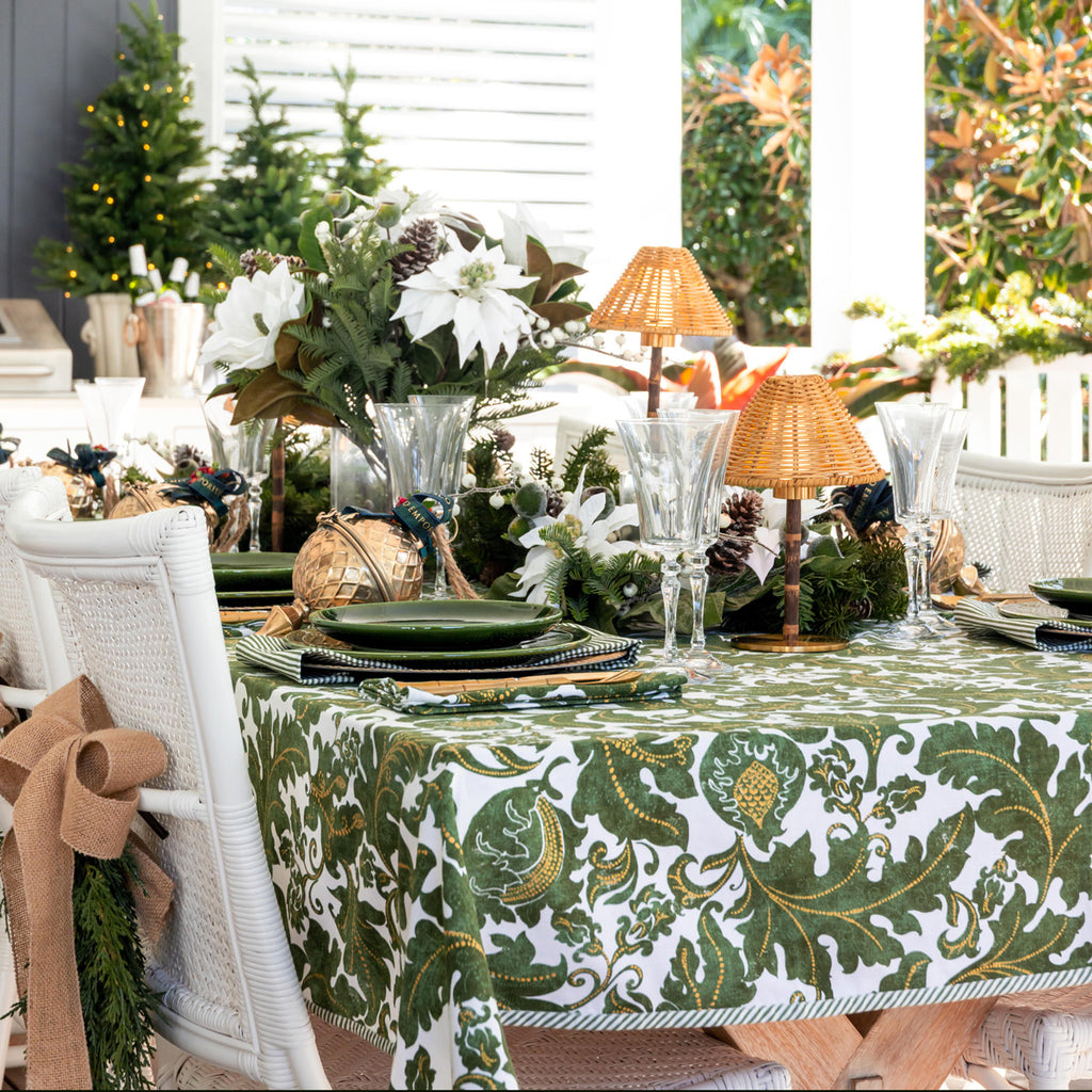 Batik Verdigris Christmas Napery Collection styled on a table - you can see the striped tablecloth edge.