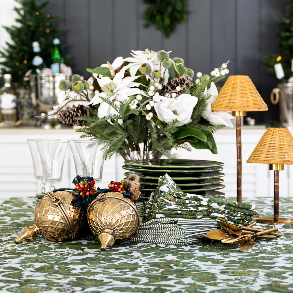 Batik Verdigris Christmas Napery Collection styled with plates and napkins stacked.