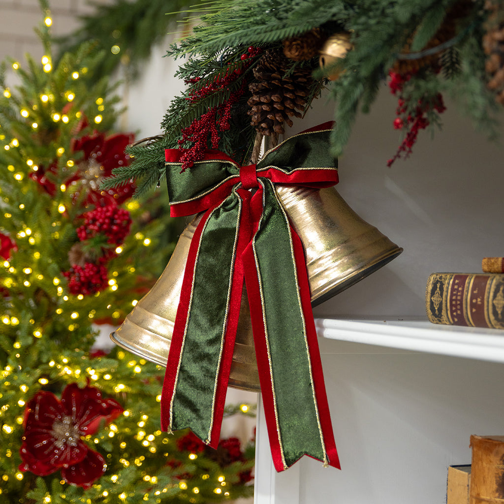 Green and red Christmas bow on gold bells