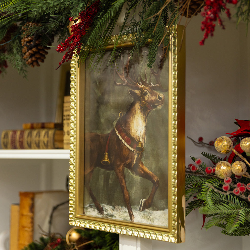 Christmas deer print styled on a bookshelf for Christmas.