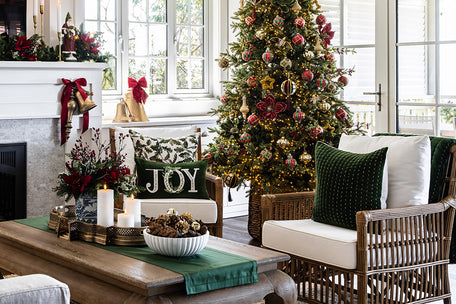 A living room decorated for Christmas in greens and red.