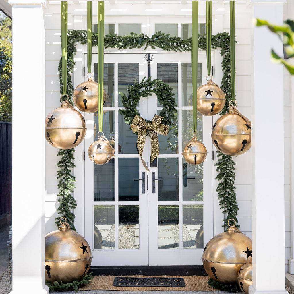 Classic Garland With Pineapple Ball Lights Styled on Door with Gold Bells Hanging