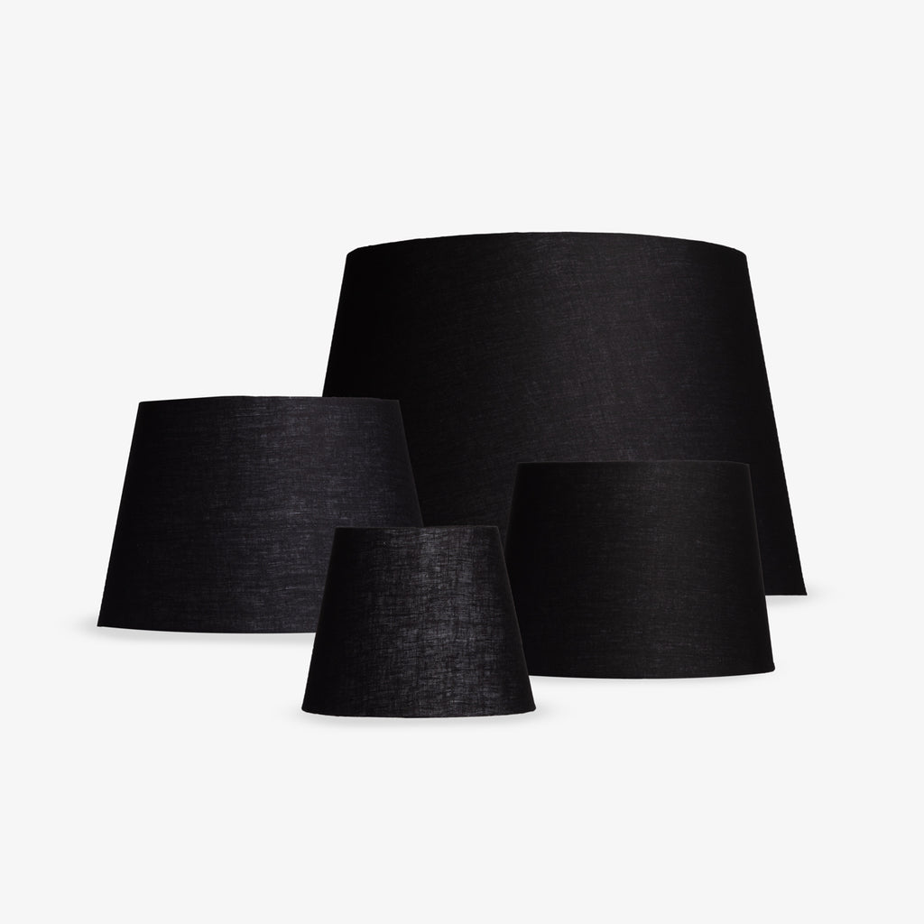 Group of black lampshades on a white background