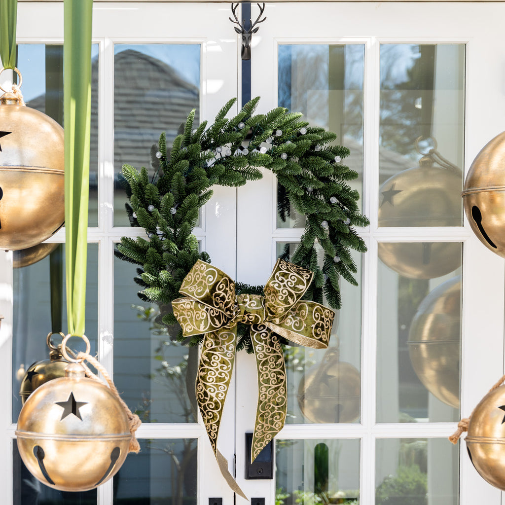 Classic Wreath With Pineapple Ball Lights Styled on Door with Green Ribbon