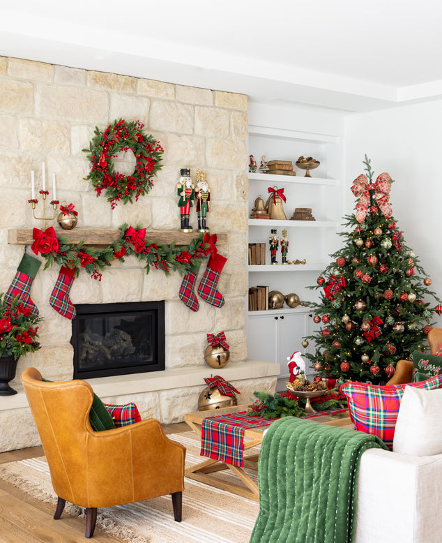 A living room decorated for Christmas in traditional colours of red, green and gold with a touch of tartan.