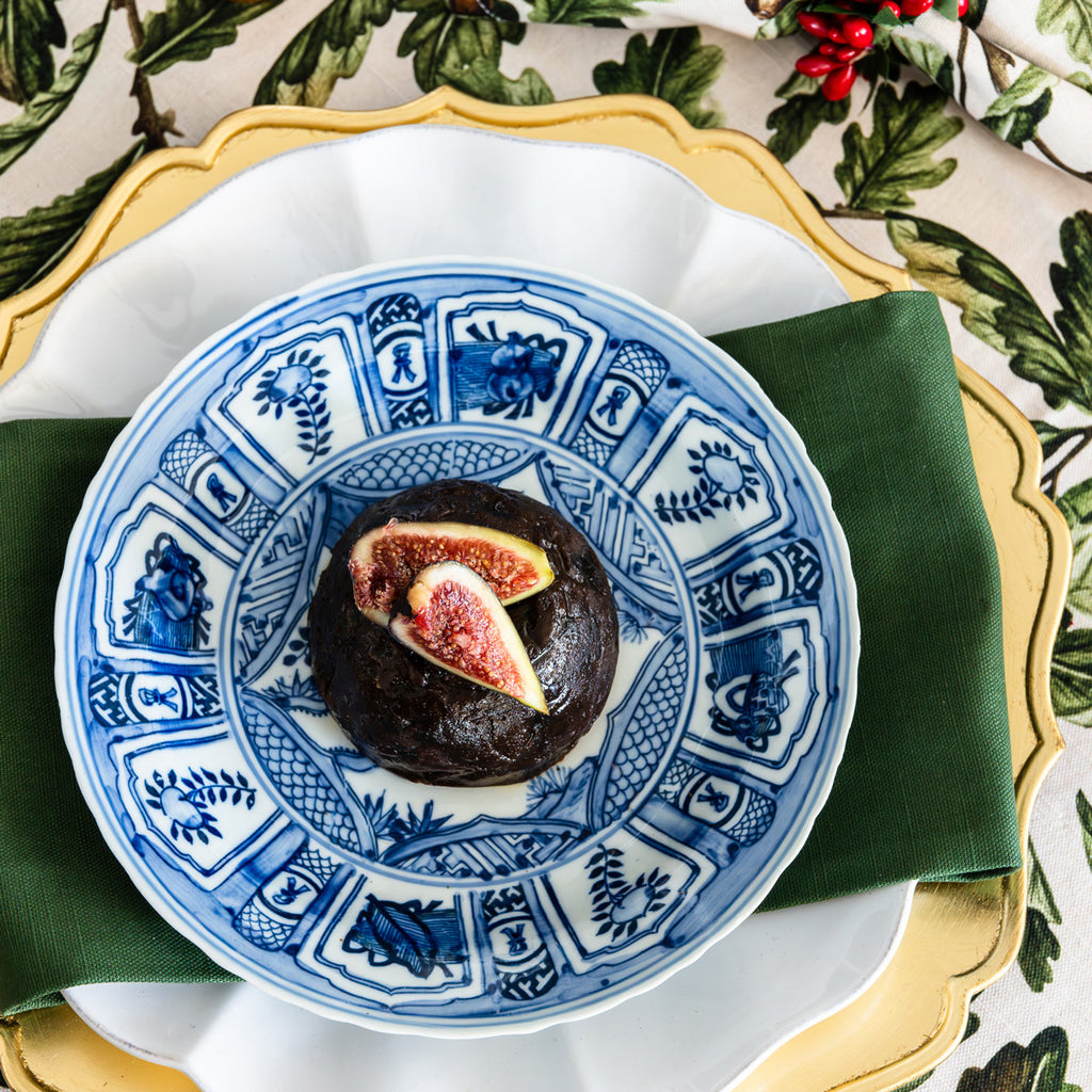 Christmas pudding displayed on a blue and white ceramic plate.