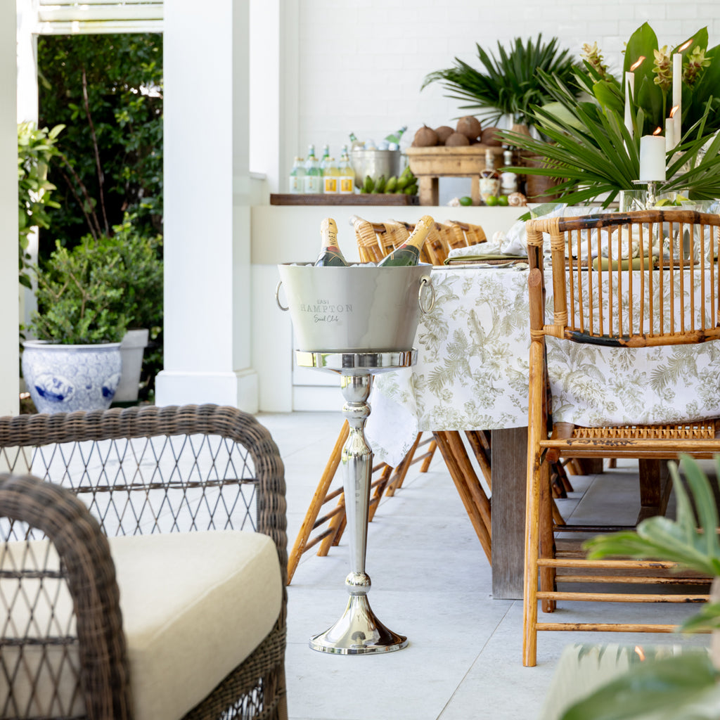 East Hampton Social Club Metal Ice Bucket On Stand Styled outside next to Island dining table