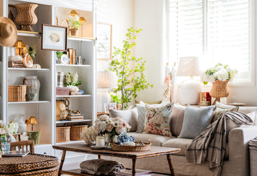 Living room with a beige sofa, coffee table, and decorative items.