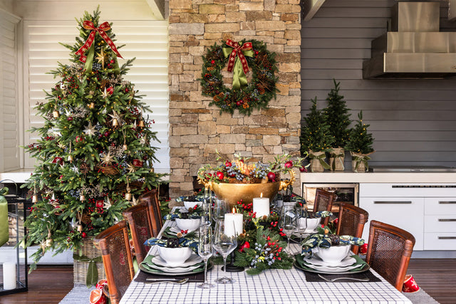 An outdoor dining area that has been styled for Christmas in a modern farmhouse style.