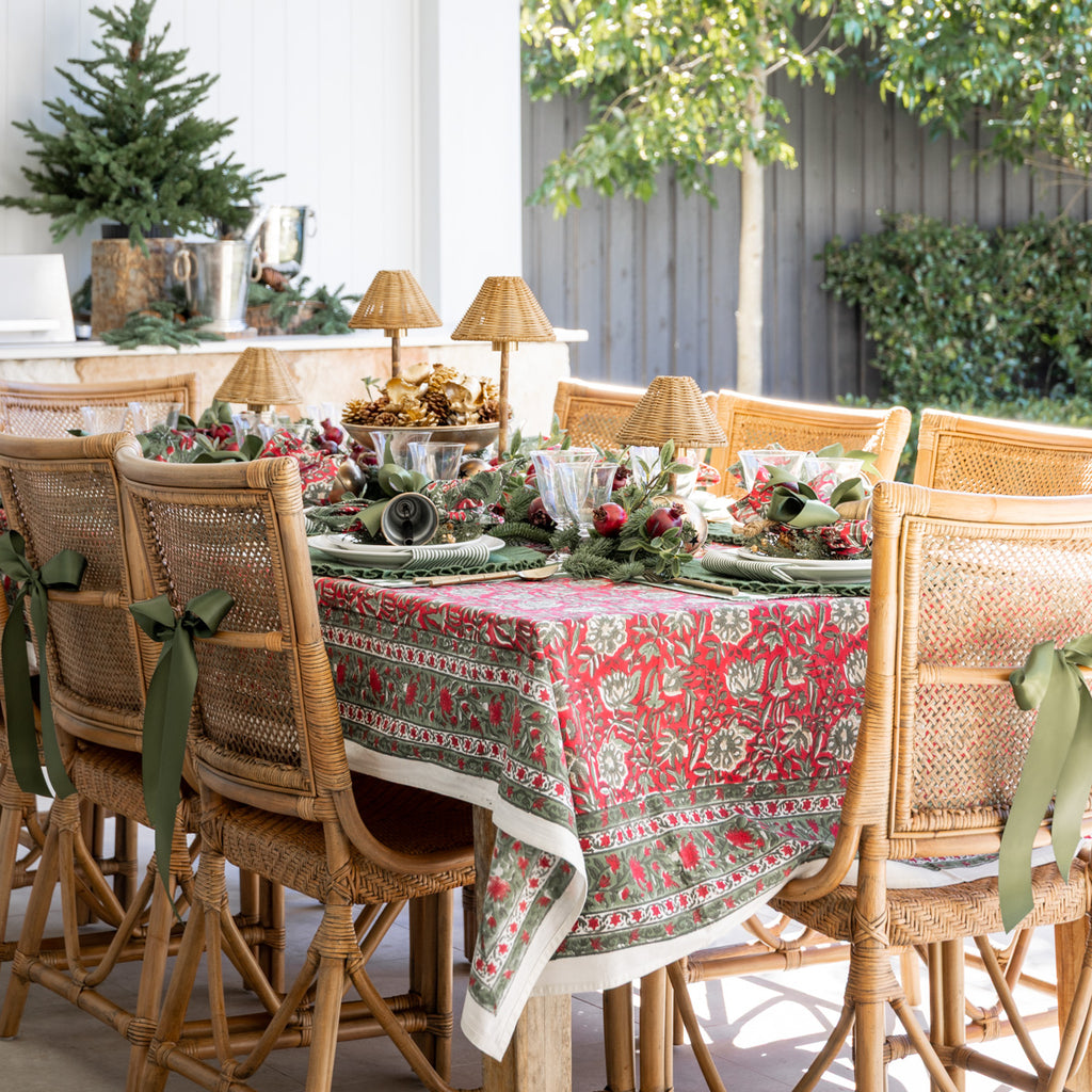 Festive Red Rose Tablecloths Styled on Outdoor Dining Table with Christmas Accents
