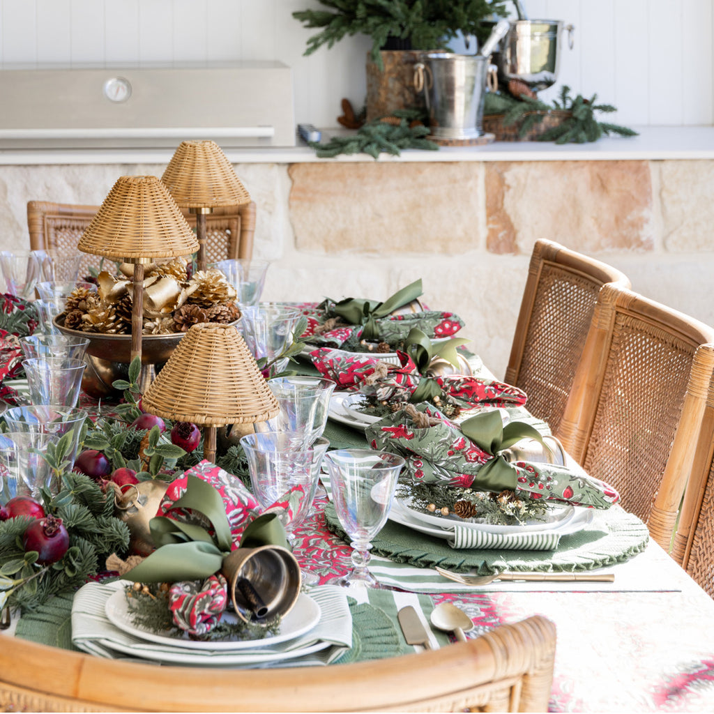 Festive Rose Christmas Napery Collection styled with green and red floral napkins.