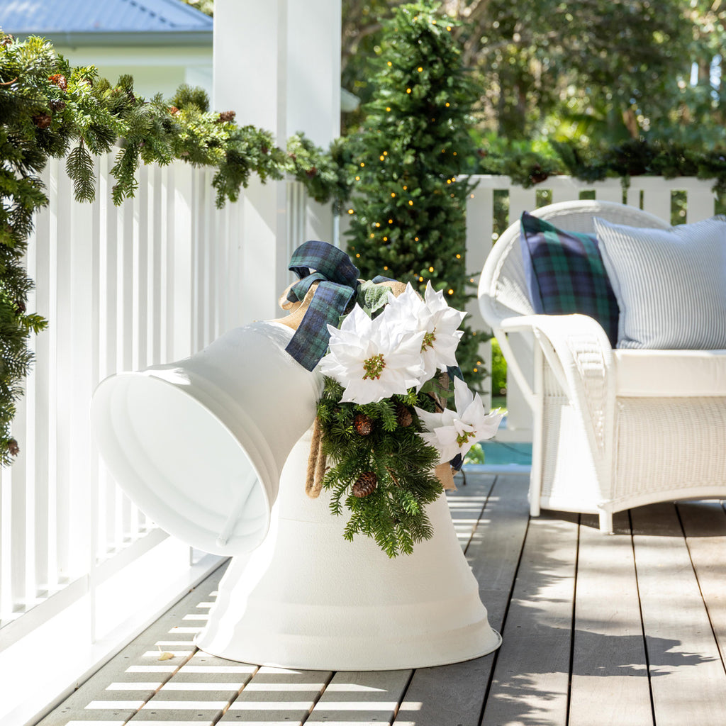 White metal bells with added poinsettia, foliage and ribbon.