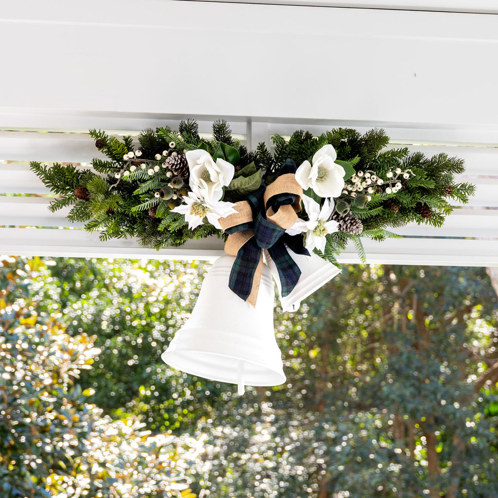 White bells tied with green foliage and ribbon.