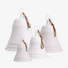 Set of four white ceramic bells with brown rope on a white background