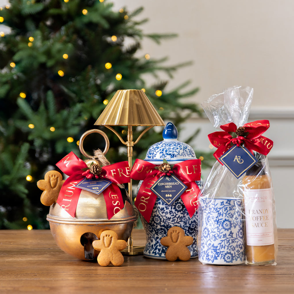 Gingerbread Men Star Bell Ornament Styled on table with Other Christmas Gifts
