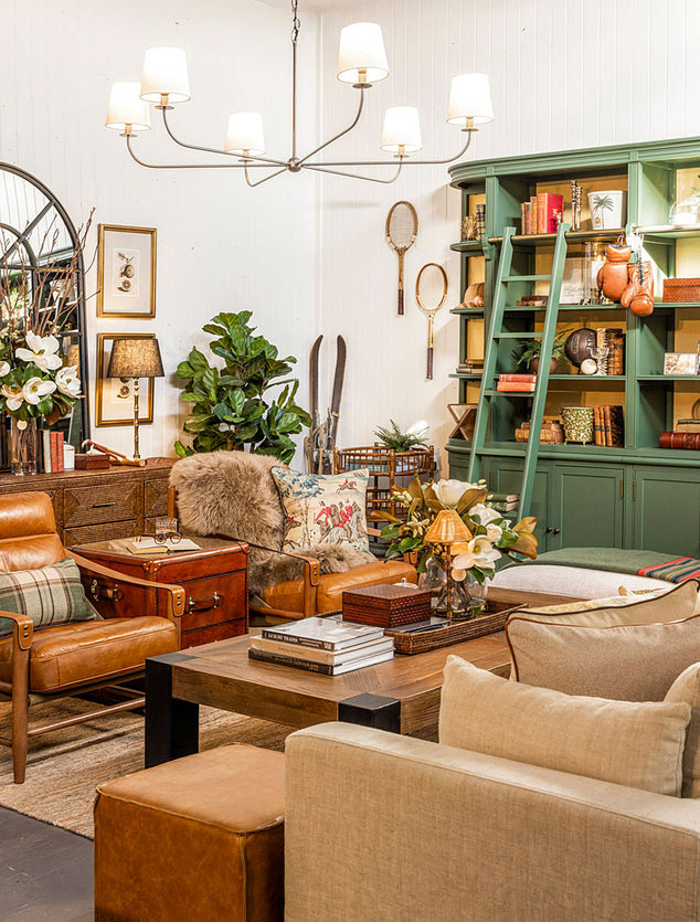 Living room with brown leather sofa, wooden coffee table, and decorative items.