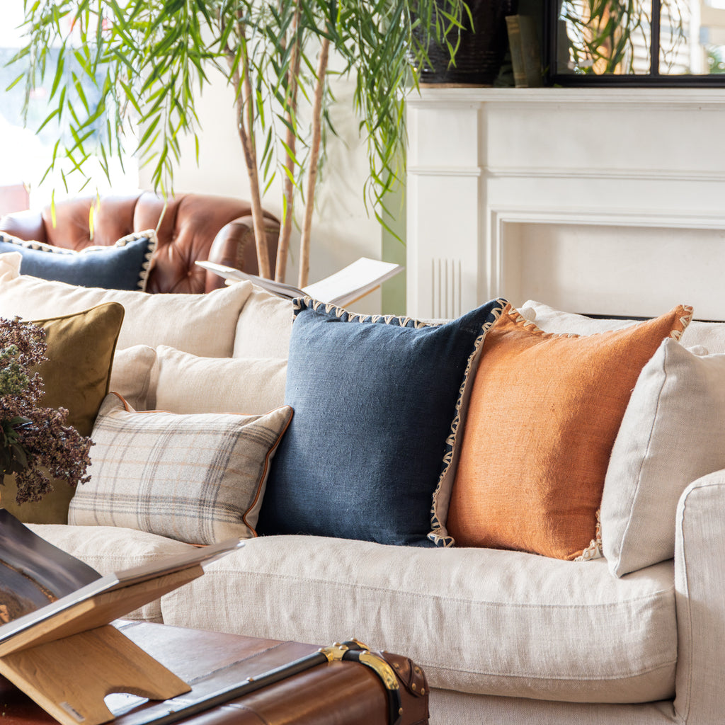 Kimberley Navy Blue Linen Cushion Cover Styled on Sofa with Rust Kimberley Cushion