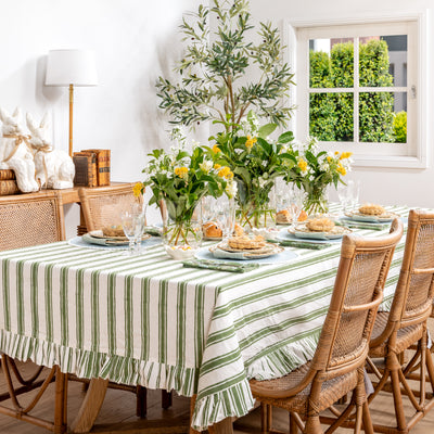 Laya Sage Wide Stripe Ruffled Tablecloths Styled on Easter Table with Florals and Bamboo Dinnerware