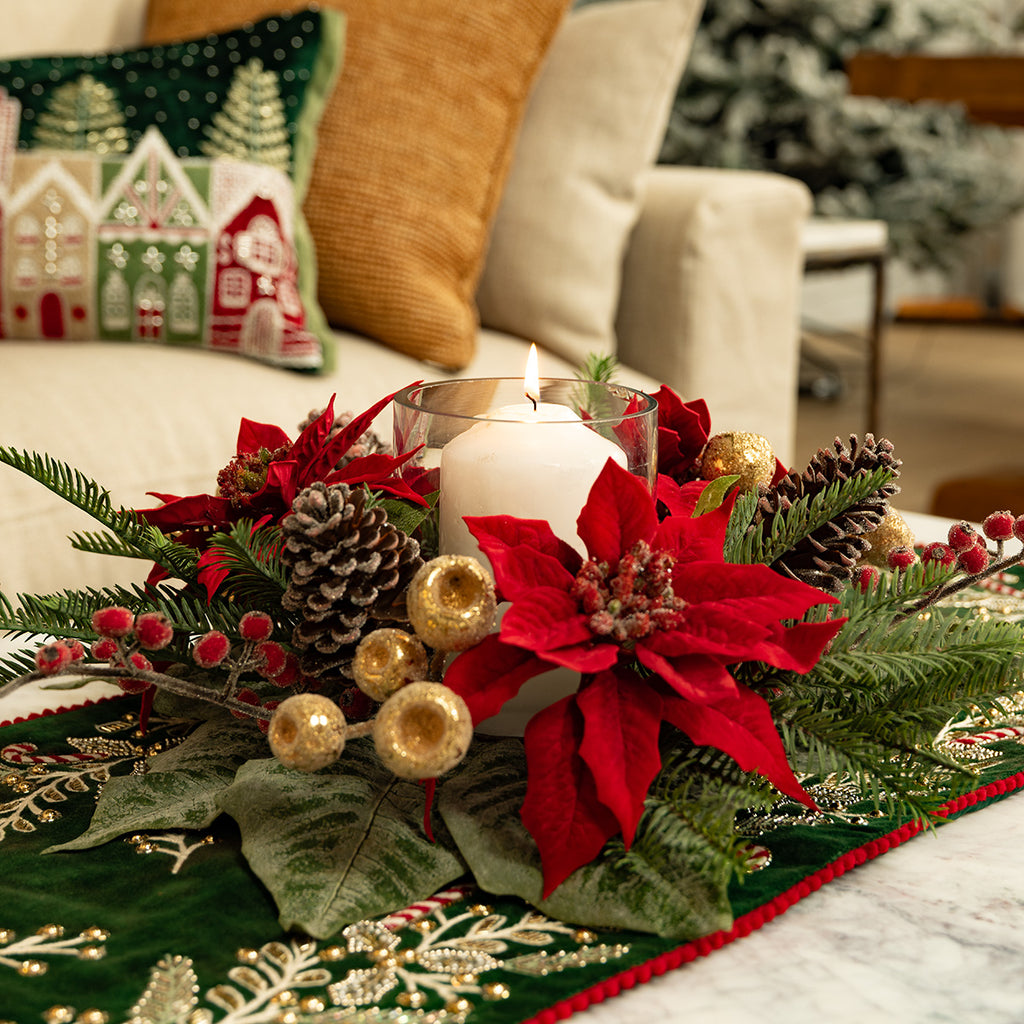 Red magnolia and poinsettia candle holder centrepiece.